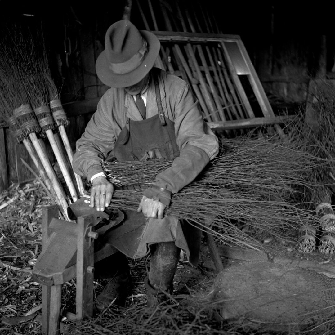 A chap making a besom broomstick A craftsman making a besom broomstick. (MERL PH1/45)