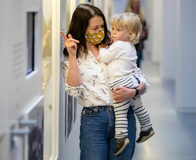 Two visitors, a mother and a child, in The MERL galleries.