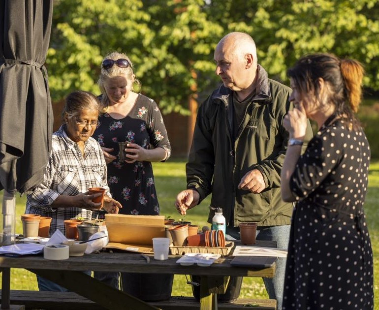 People taking part in an activity in The MERL garden.