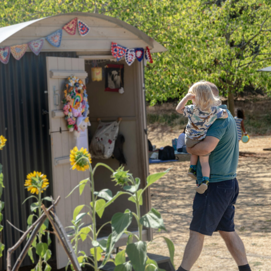 A father and a baby in The MERL garden.