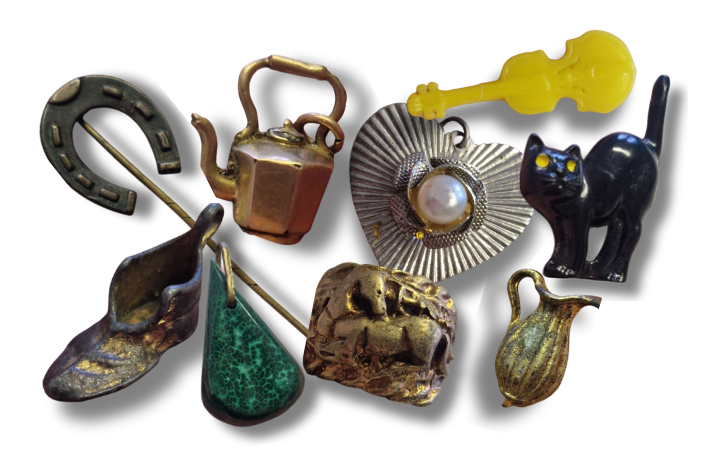 Twelve small, decorative charms in a variety of shapes, including a horseshoe, a book, and a hand.